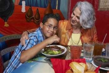 Close-up of a boy with his grandmother in a restaurant