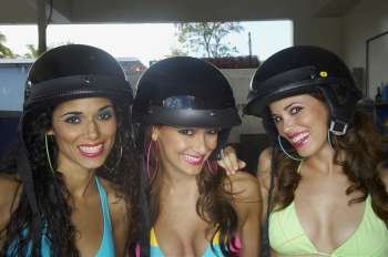 Three sexy young women wearing helmets