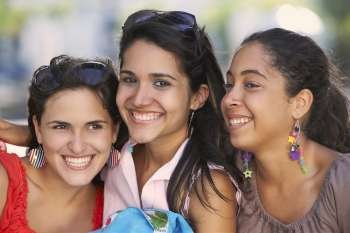Close-up of three young women smiling