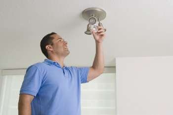Man checking a light bulb