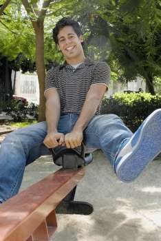 Portrait of a young man on a seesaw