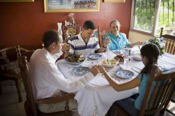 High angle view of a mature couple with their son and daughter at a dining table