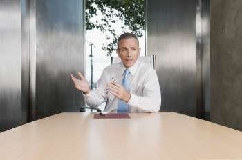 Businessman giving a presentation in a board room