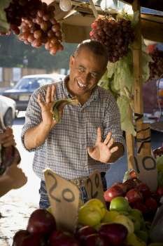 Fruit seller holding money and gesturing, Santo Domingo, Dominican Republic