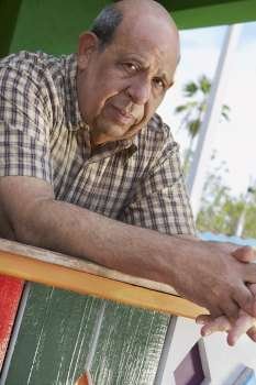 Portrait of a senior man leaning on a railing