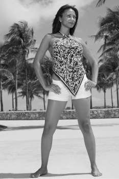 Mature woman posing with arms akimbo on the beach, South Beach, Miami Beach, Florida, USA