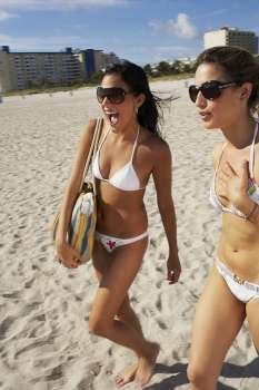 Young women walking on the beach