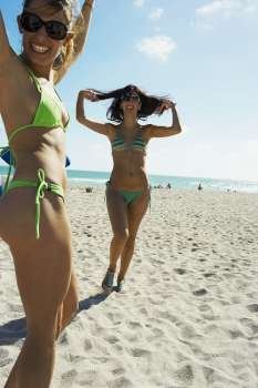Young women dancing on beach