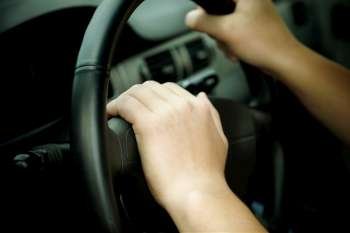 hands on the wheel, selective focus on nearest part