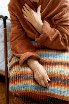 old woman in hospital, selective focus on nearest hand