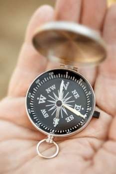 small compass on the hand, selective focus,lens blur