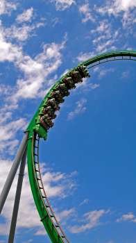 People on a green roller coaster ride.