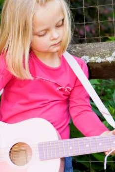 Girl playing guitar, close-up