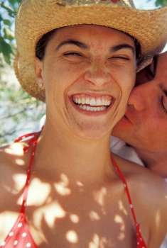 Man kissing woman, smiling
