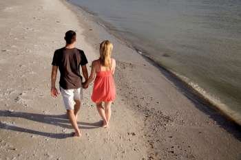 Young couple walking along beach, elevated view