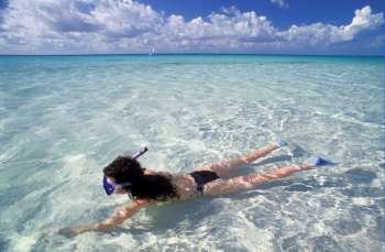 Woman snorkeling, Isla Majuerhus, Mexico