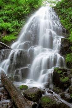 Blurred motion shot of remote waterfall splashing in forest