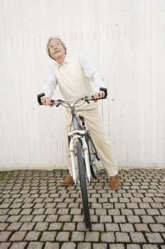 Old asian man on a bike