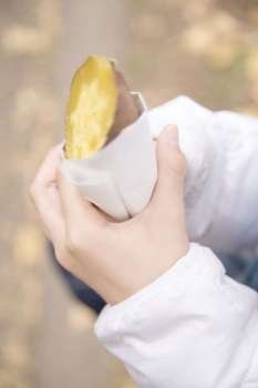 Hands having a sweet potato
