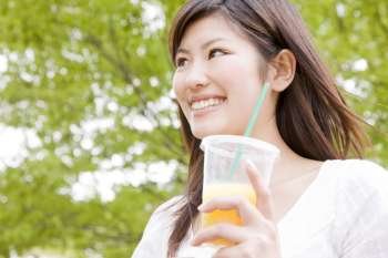 Japanese young woman drinking orange juice