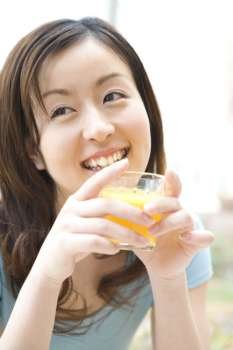 Japanese woman drinking a orange juice