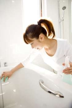 Japanese woman cleaning up the bathtub