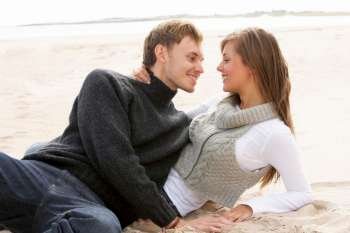 Young Romantic Couple Relaxing On Beach Together