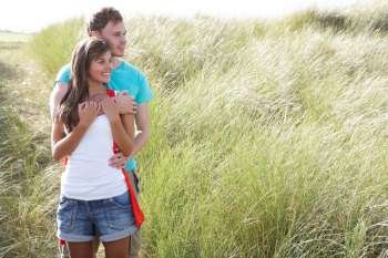 Romantic Young Couple Standing Amongst Dunes 