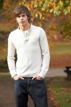 Teenage Boy Standing In Autumn Park
