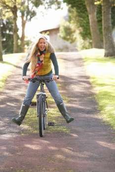 Portrait Of Young Woman With Cycle In Autumn Park