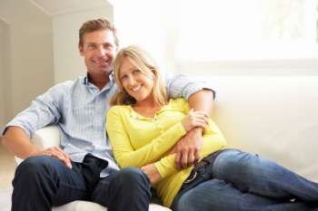 Couple Relaxing On Sofa At Home