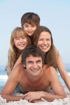 Young Family Having Fun On Beach Holiday