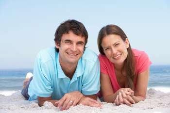 Young Couple Relaxing On Beach