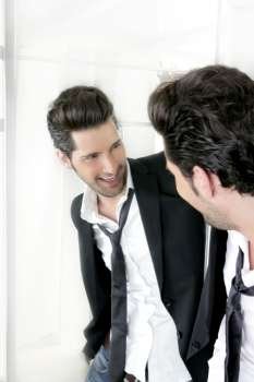 Handsome narcissistic suit proud young man looking himself in the mirror 