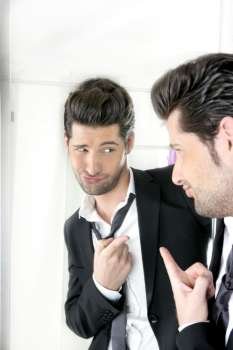 Handsome suit proud young man humor funny gesturing in a mirror 