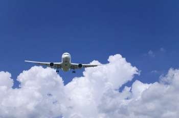 Aeroplane through  a cloudy blue sky