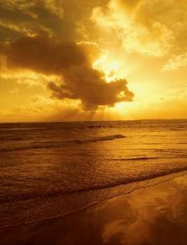 Golden morning sunburst over ocean.