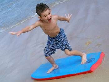 Boy on boogie board at the beach.