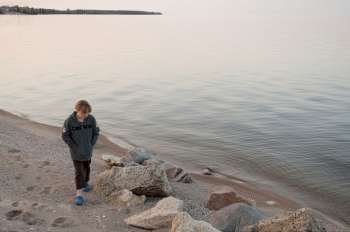 Girl along the shoreline in Gimli, Manitoba, Canada