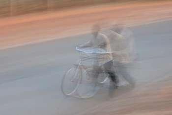 Blurred picture of African man with a bicycle