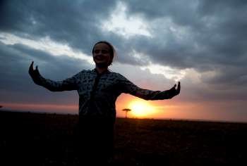 Silhouette of girl against Kenya sky at sunset