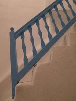 Blue railing on staircase in Mydonos Greece