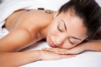 A shot of a black woman lying down at a spa