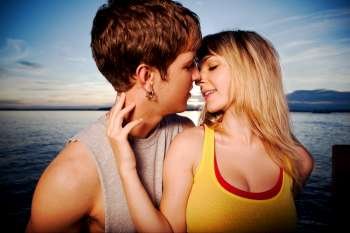 A shot of a young caucasian couple kissing outdoor