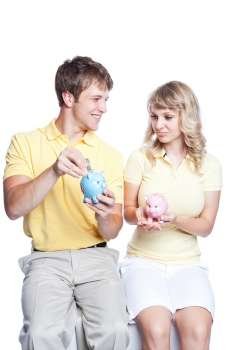 A young couple holding piggy banks, can be used for finance or saving concept