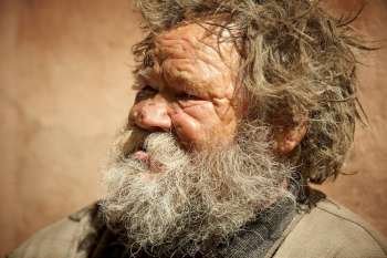 homeless man talking about hard life, special toned photo f/x, focus point on eye