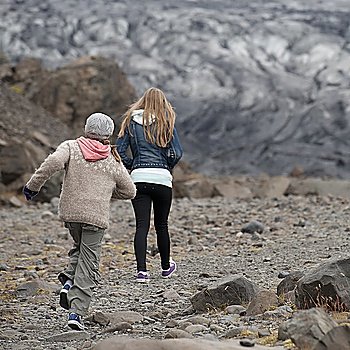 Girls walking away on glacial debris