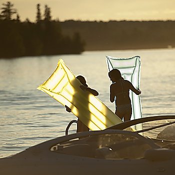 Two girls with float mattresses at Lake of the Woods, Ontario