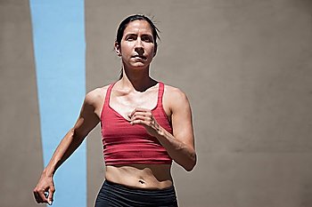 Pretty, focused woman runs to keep in shape.