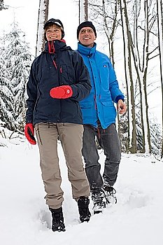 Mature couple walking in the snow
